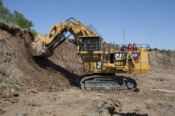 A CAT excavator machine digging for a mining operation.